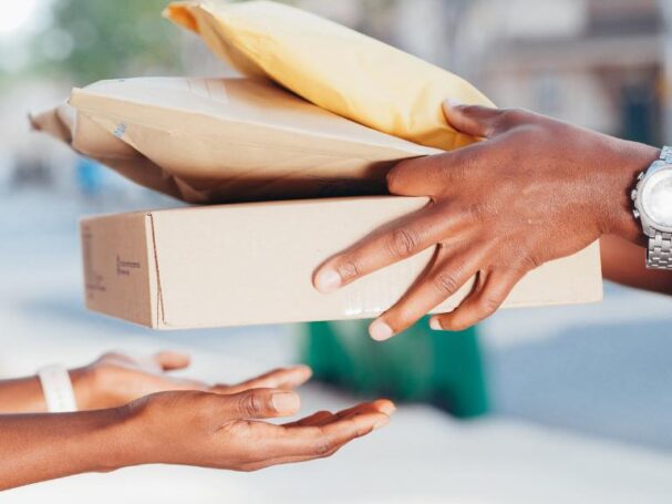 delivery man taking boxes from customer